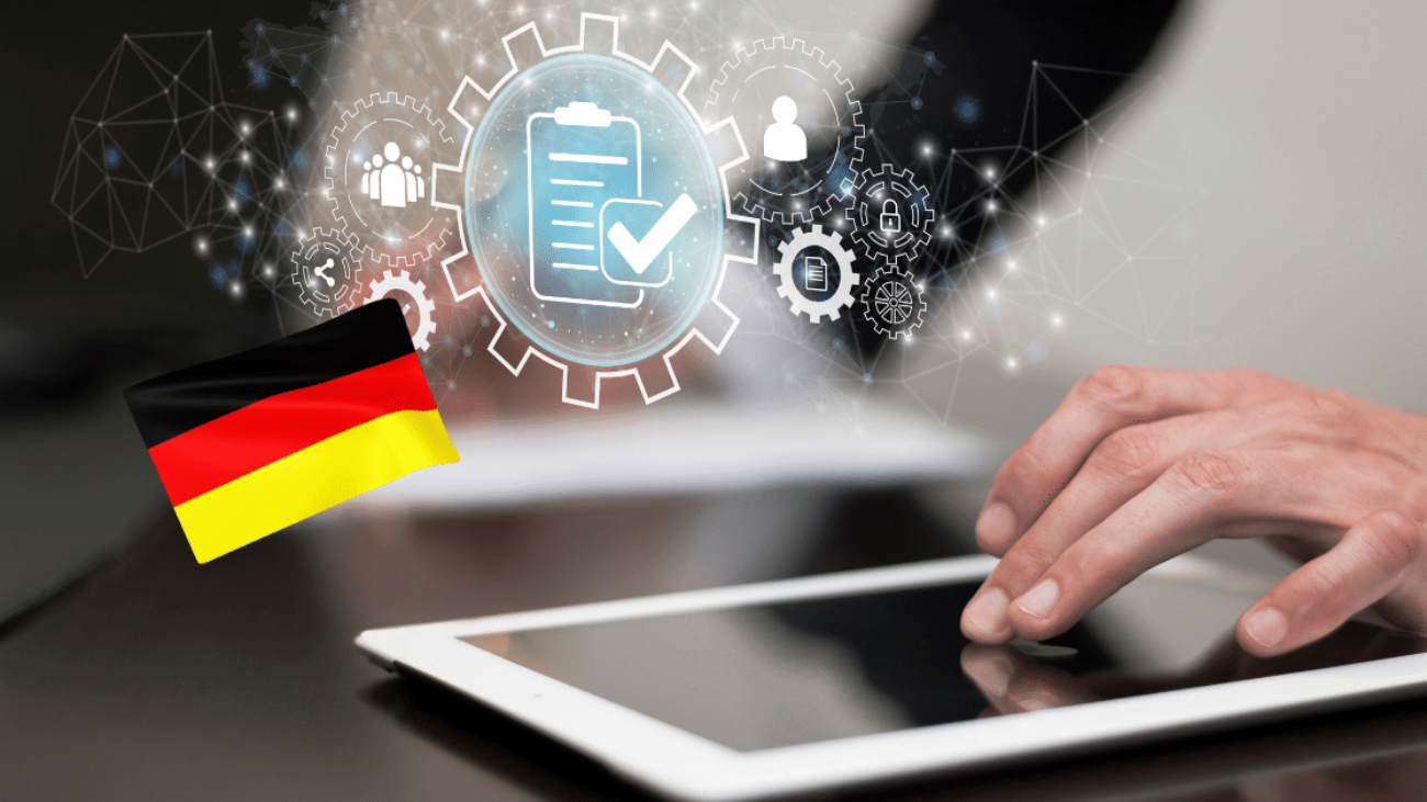 Hands using a tablet with digital icons and German flag, representing the implementation of electronic invoicing in Germany.