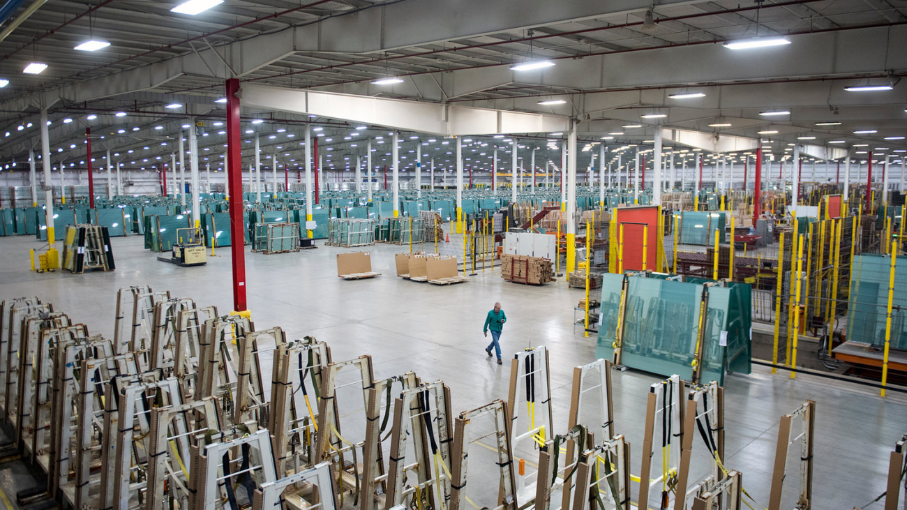 An employee at Cardinal Glass walks through the warehouse at the Winlock plant on Thursday, April 13, 2017. On Thursday, there were about 12,000 tons of inventory on hand. Cardinal Glass can ship out 600-1,000 tons a day.